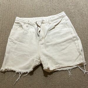 Off-white cream coloured jean shorts.